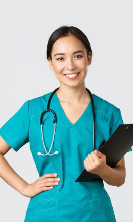 Healthcare workers, preventing virus, quarantine campaign concept. Smiling pleasant asian female physician, doctor during examination wearing scrubs and holding clipboard, white background.